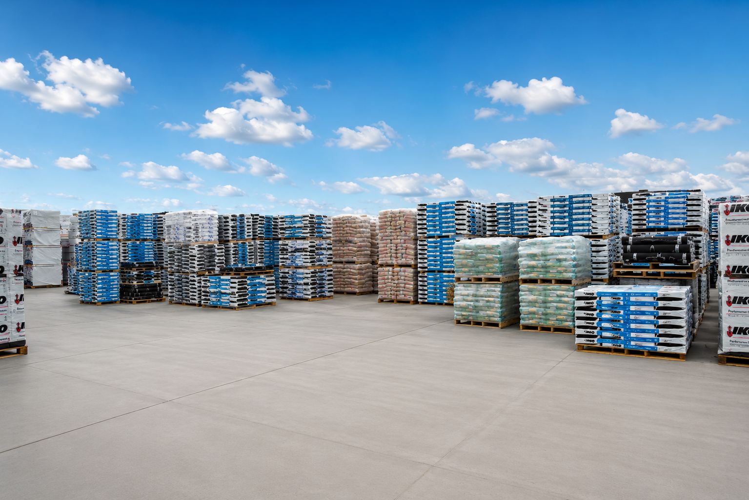 Outdoor roofing material yard with pallets of shingles